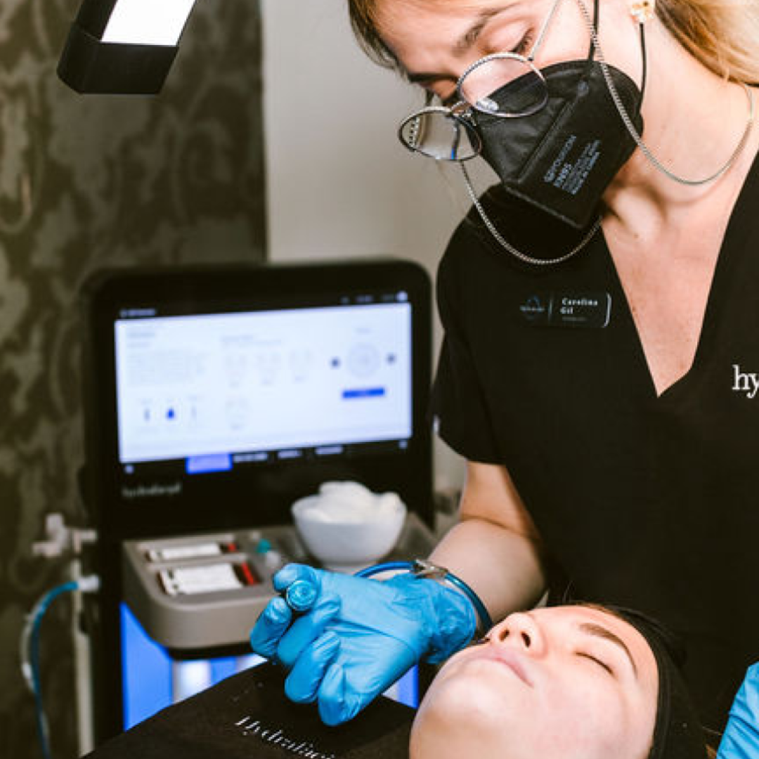 Certified Aesthetician Administering HydraFacial Syndeo at Refine Clinic
